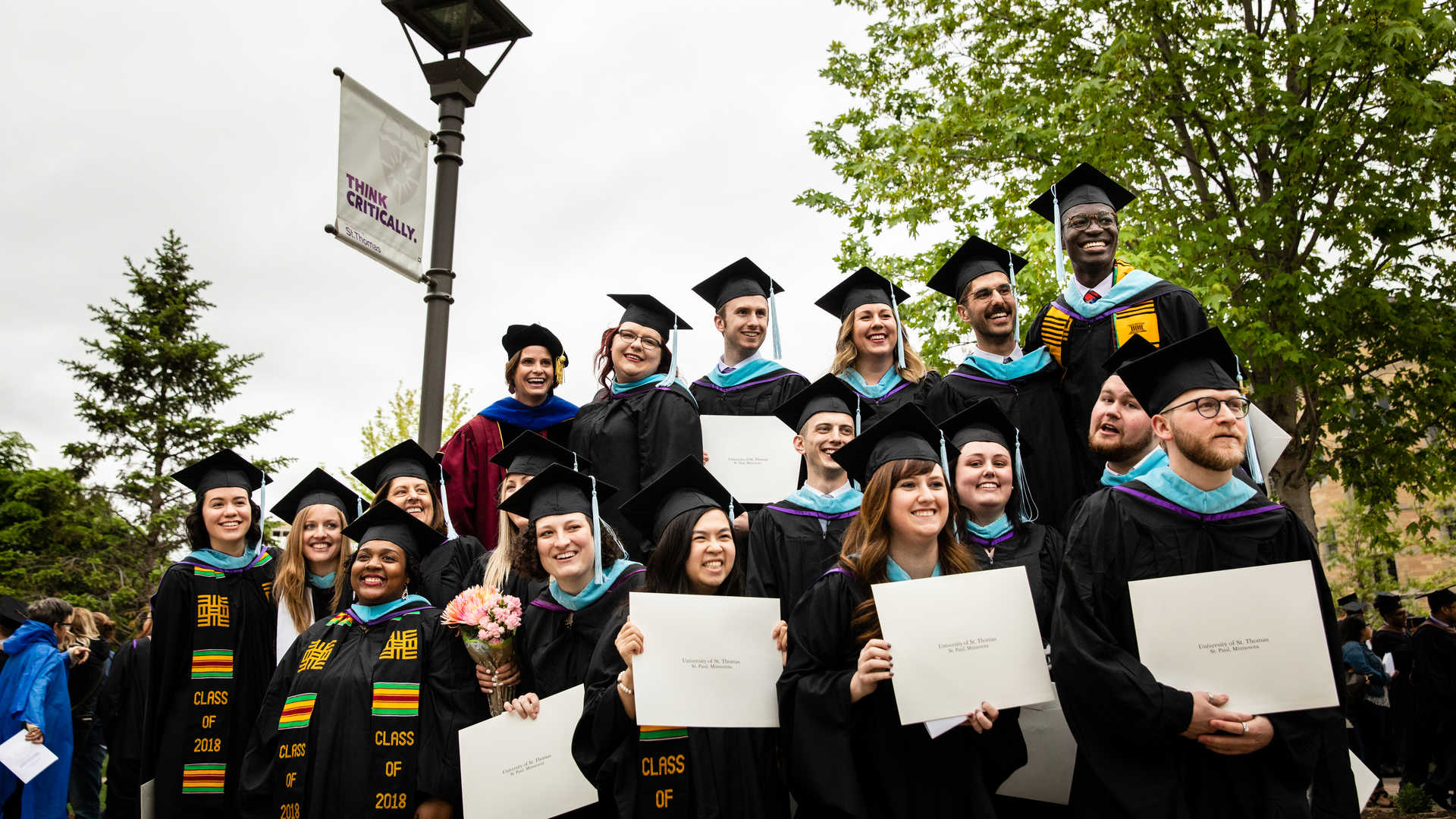 CELC graduates in group photo with diplomas 